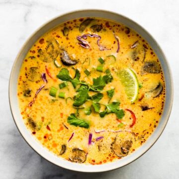 Overhead photo of Easy Thai Coconut Soup in a white bowl garnished with cilantro.