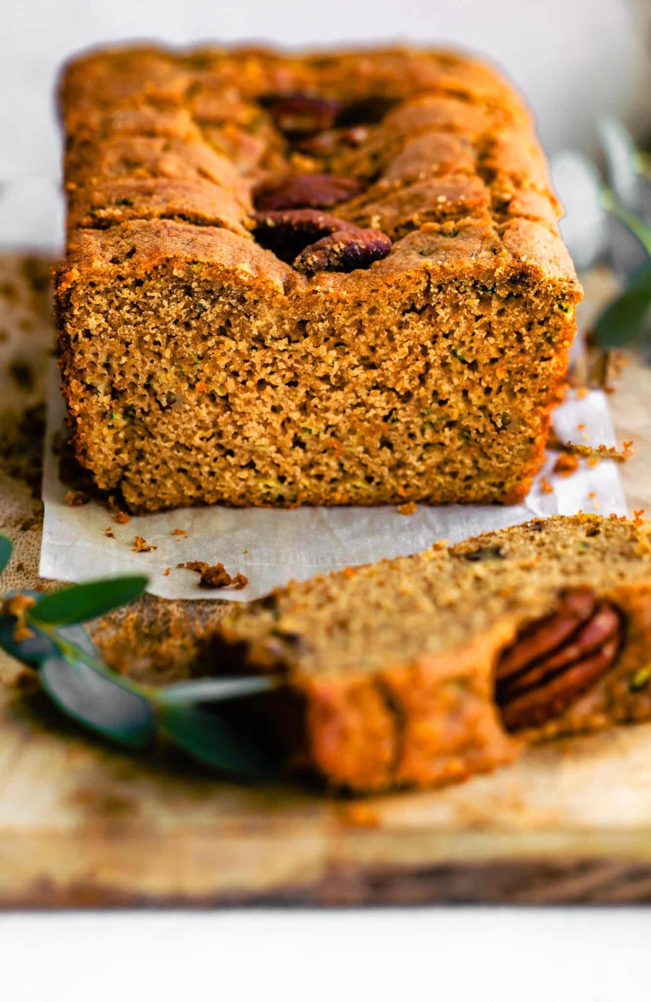 side angle photo of sliced zucchini bread on parchment paper