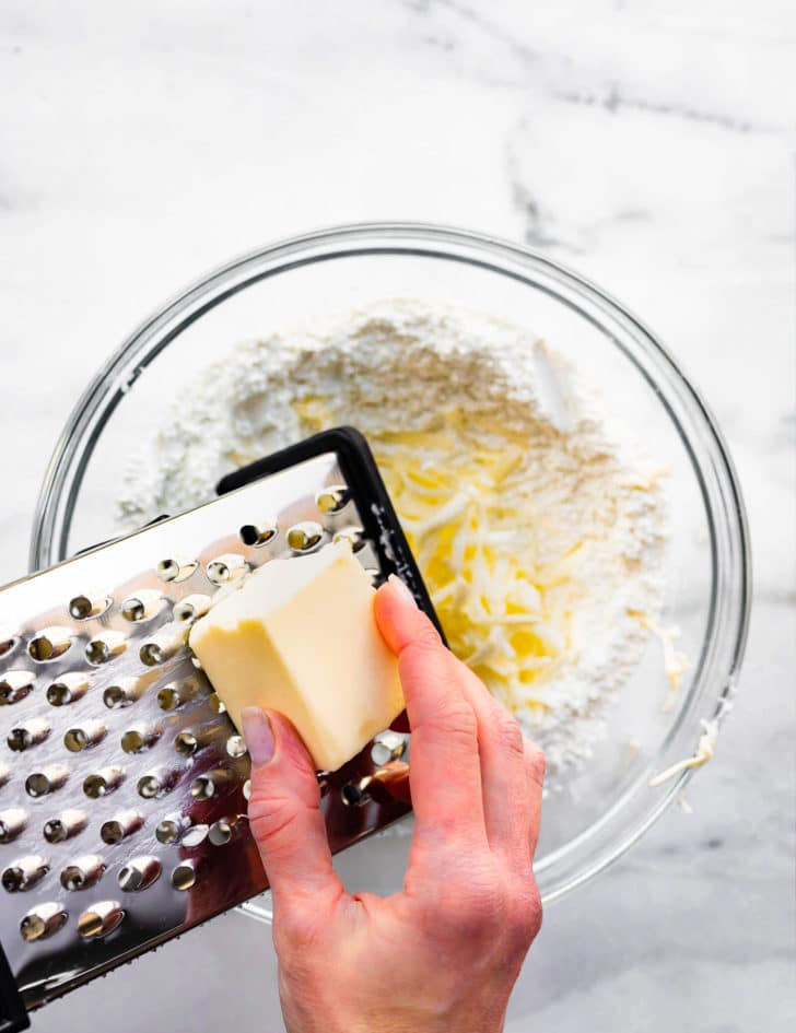 butter being grated for gluten free biscuits