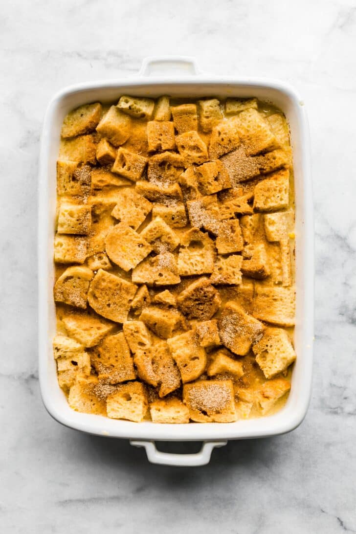 Cinnamon sugar mixture sprinkled on unbaked french toast casserole.
