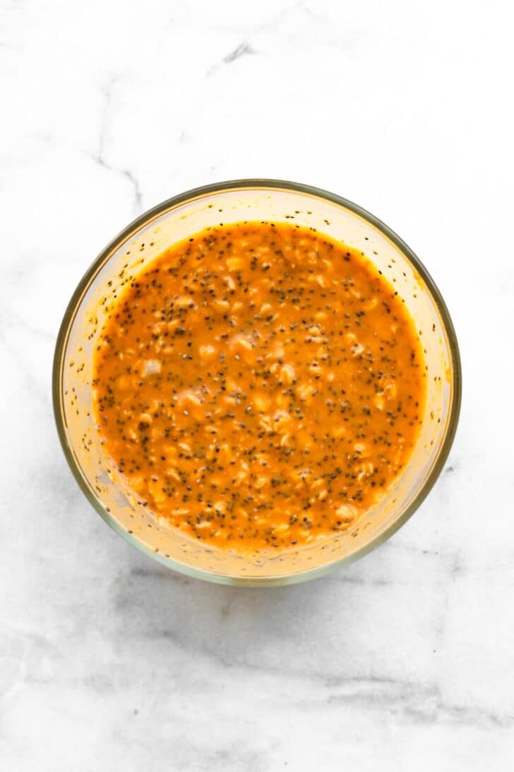 ingredients mixed in glass mixing bowl to make pumpkin overnight oats with chia.