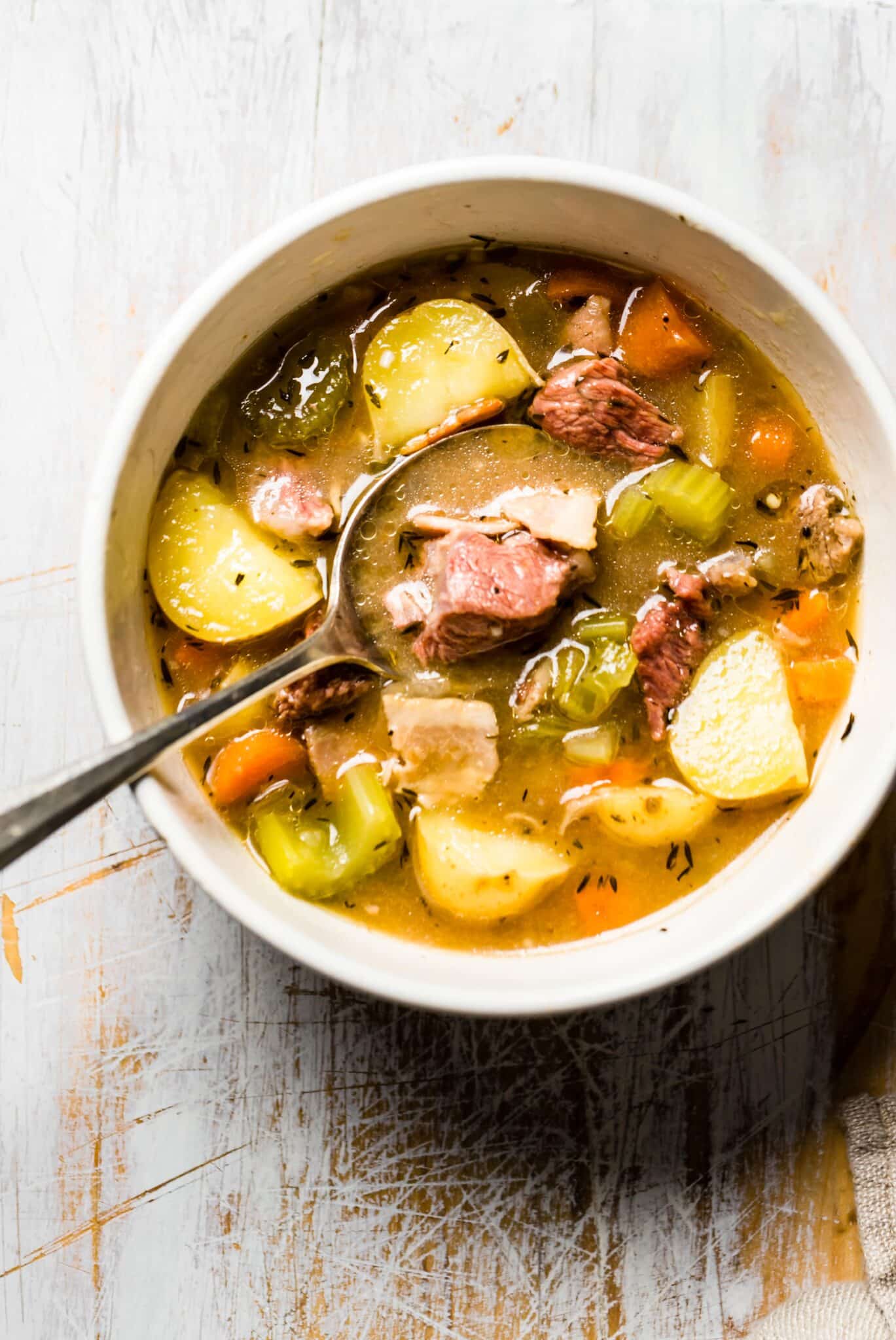 Overhead photo of a bowl of Irish Lamb Stew with a spoon in it.