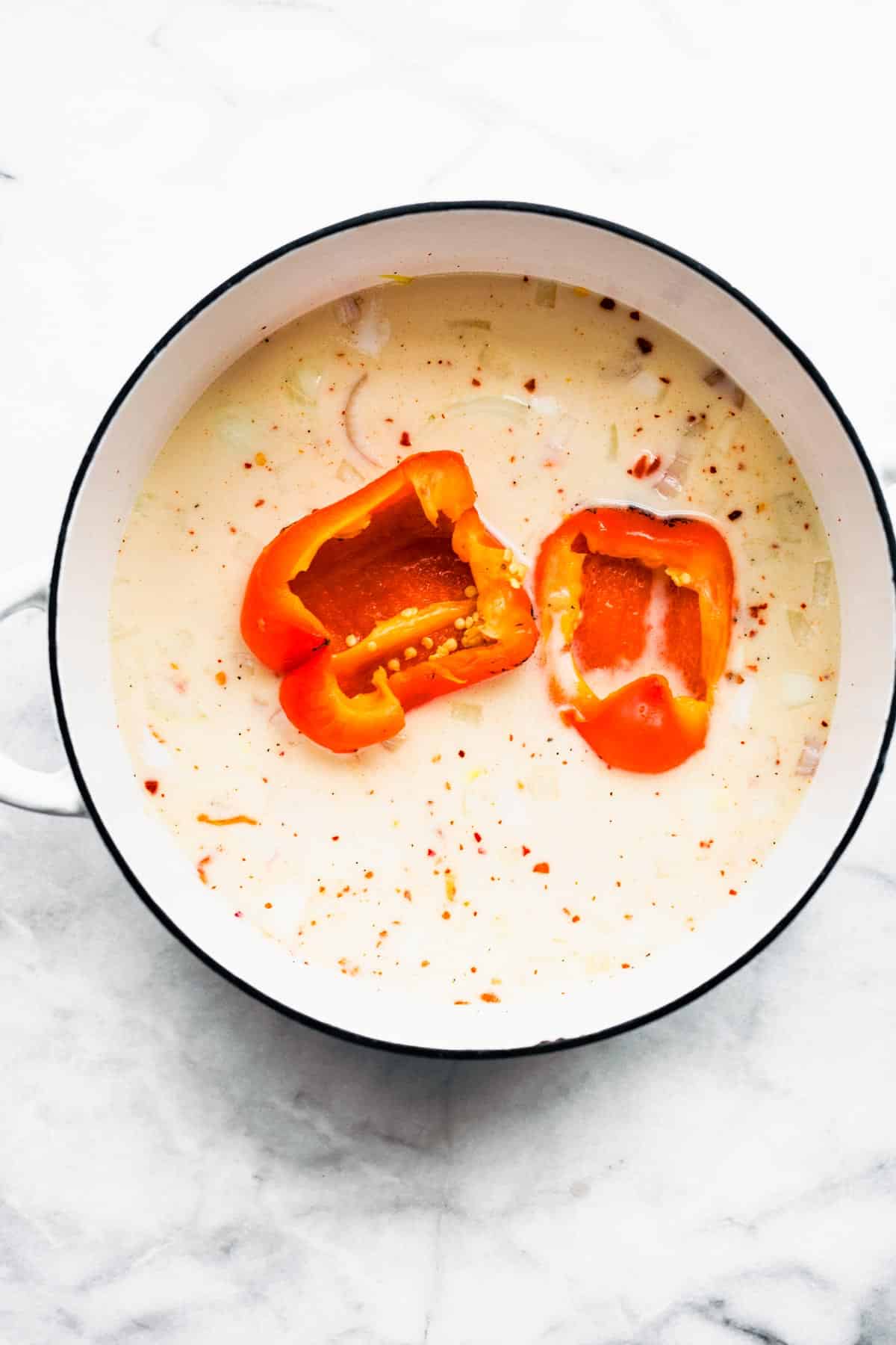 Roasted red peppers being added to the Roasted Red Pepper Soup base.