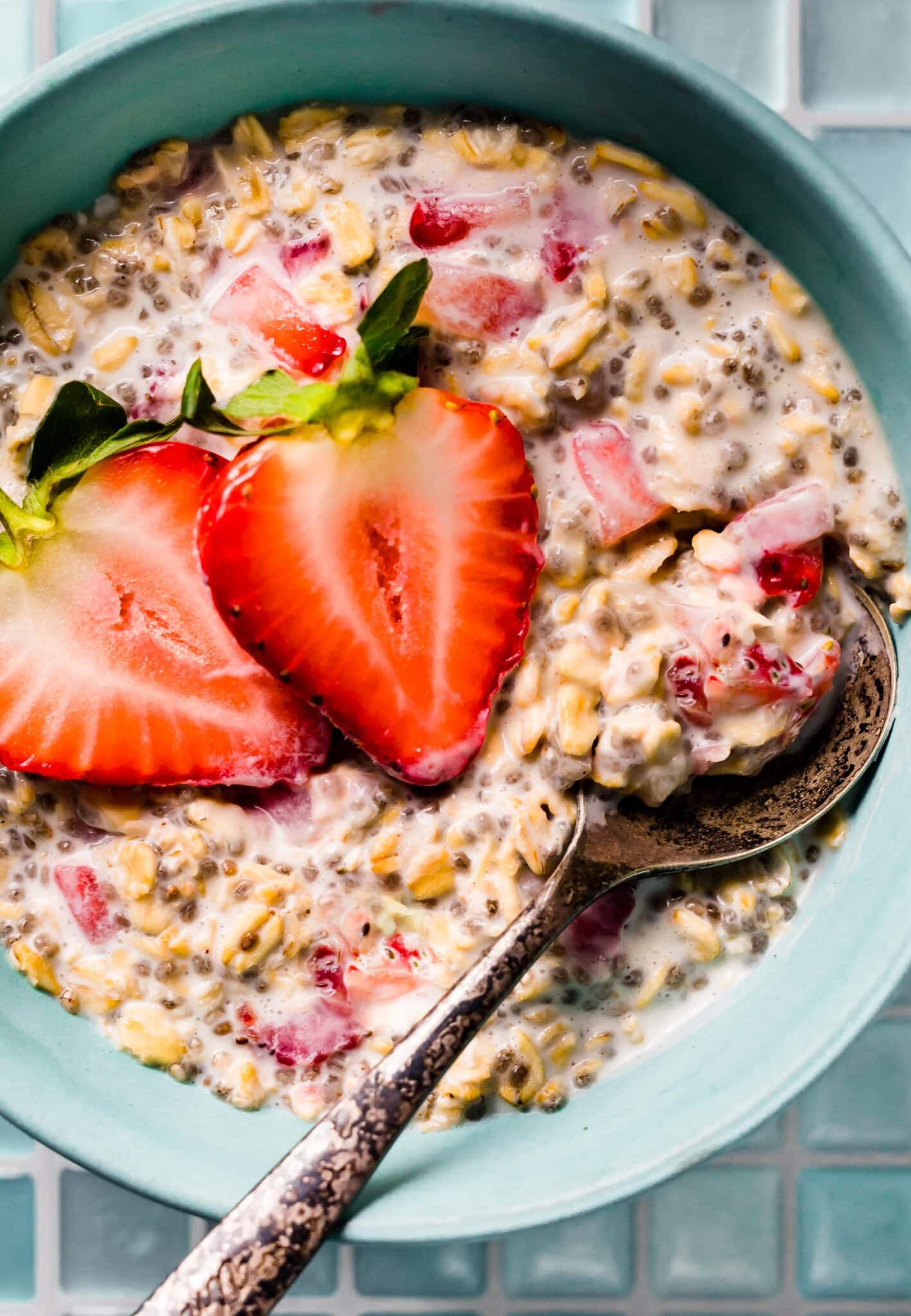 Overhead photo of strawberry overnight oats with a spoon in it.