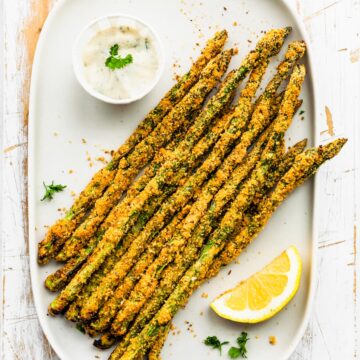 A plate of gluten free panko air fryer asparagus fries.