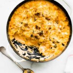 overhead: serving removed from casserole dish of gluten free cheesy pasta casserole