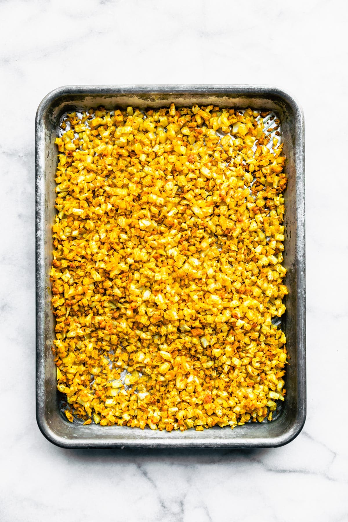 Roasted curried cauliflower on a sheet pan.