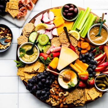 Overhead image of snack trays on a white tile tabletop.