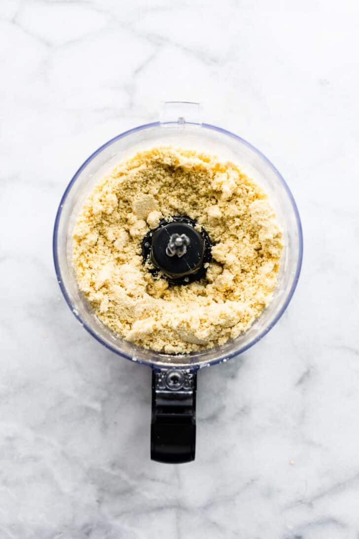 Gluten free flour blended with cold butter in a food processor for a pie crust.