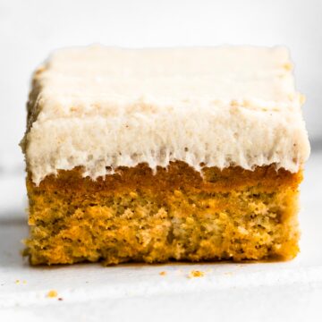 Up close side photo of gluten free frosted banana bread bars.