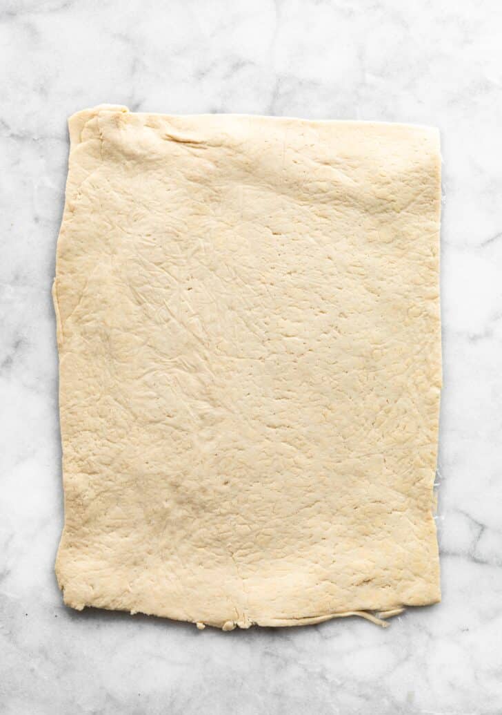 gluten free cinnamon roll dough rolled out before filling