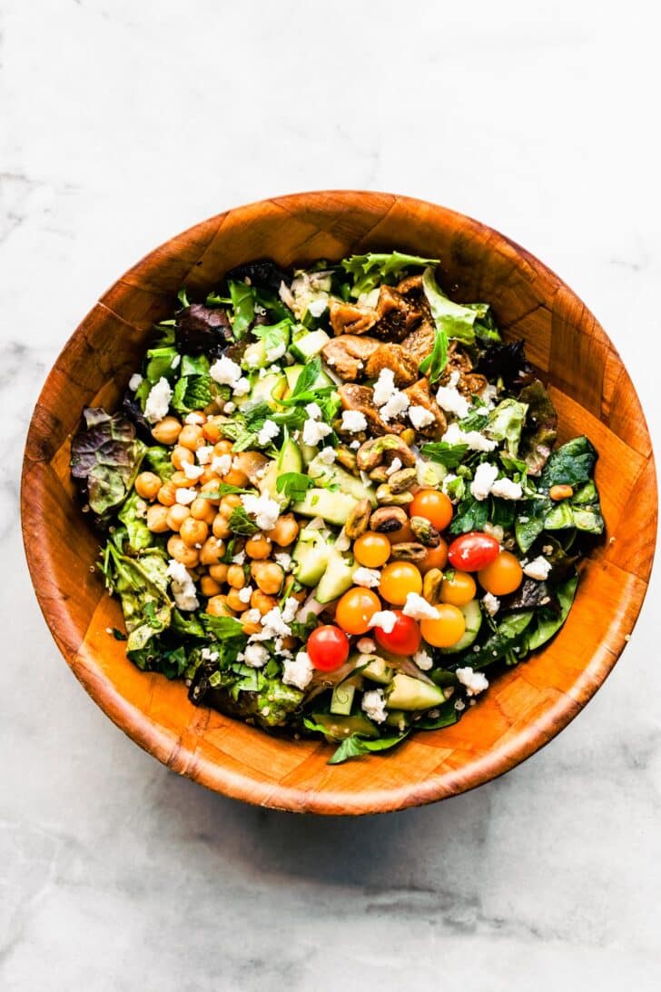Overhead view Moroccan salad with quinoa and chickpeas and fresh vegetables in bowl