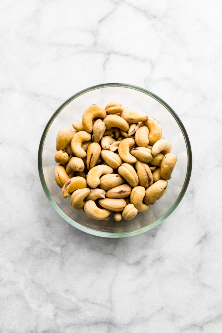 A clear bowl of cashews that were previously soaked.