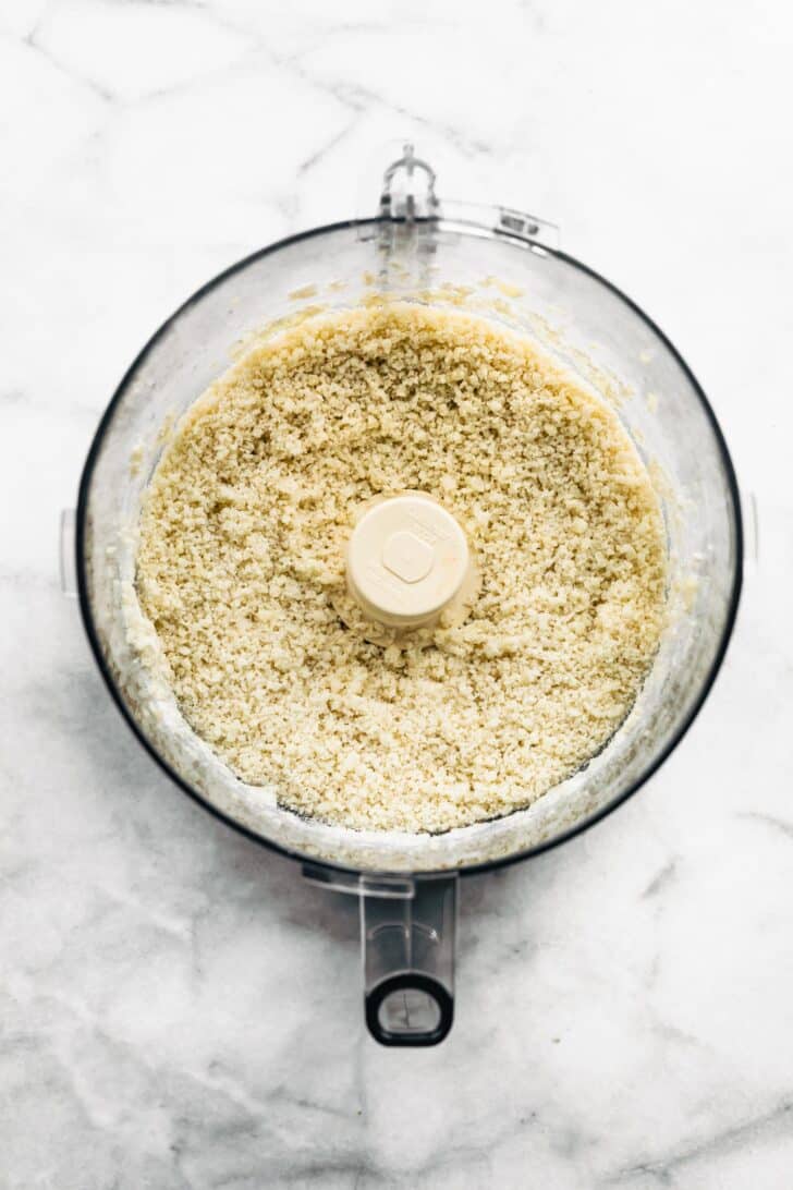 Flour mixture and riced cauliflower in a food processor.