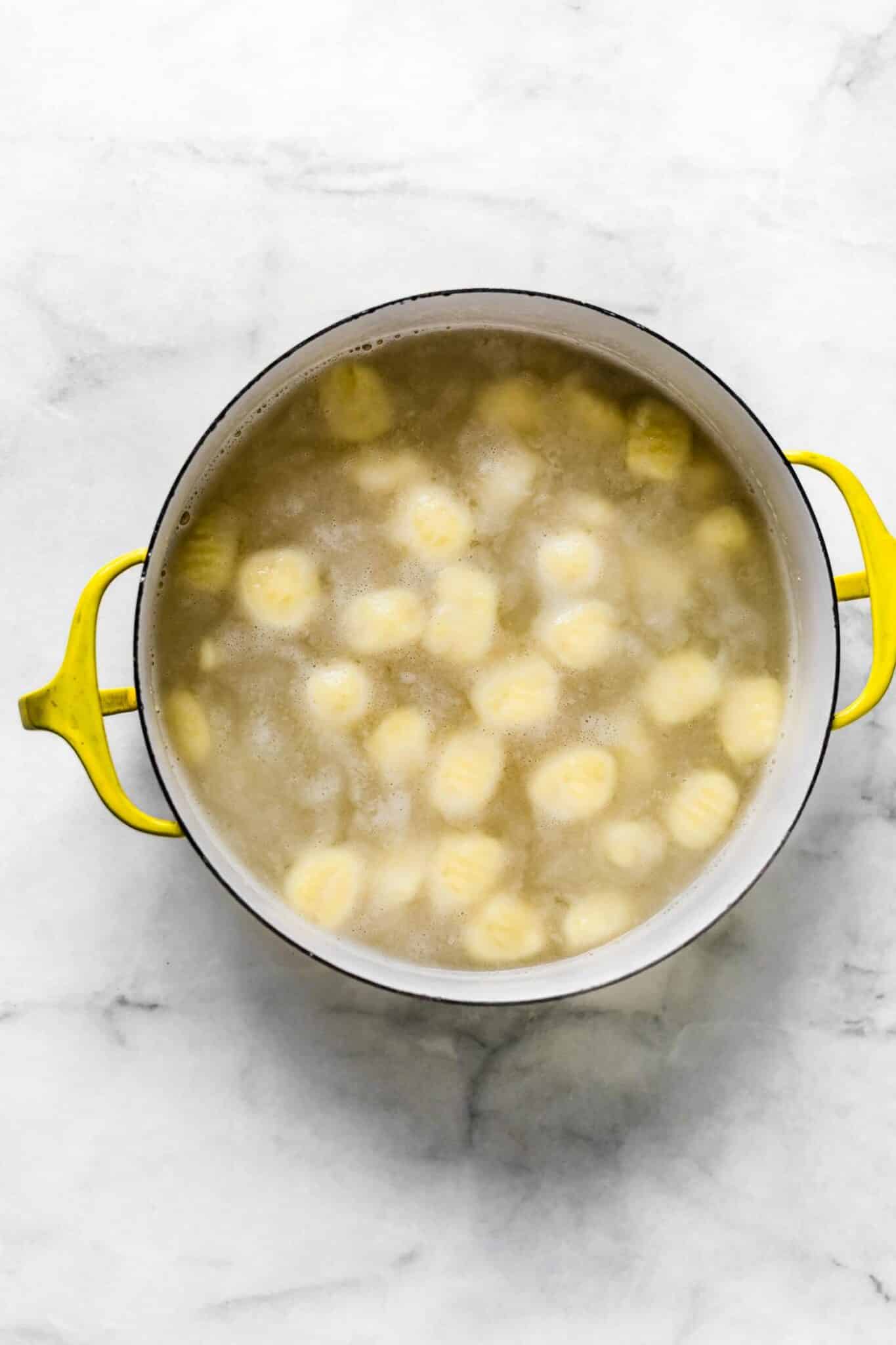 a Homemade cauliflower gnocchi recipe boiling in a pot of water.