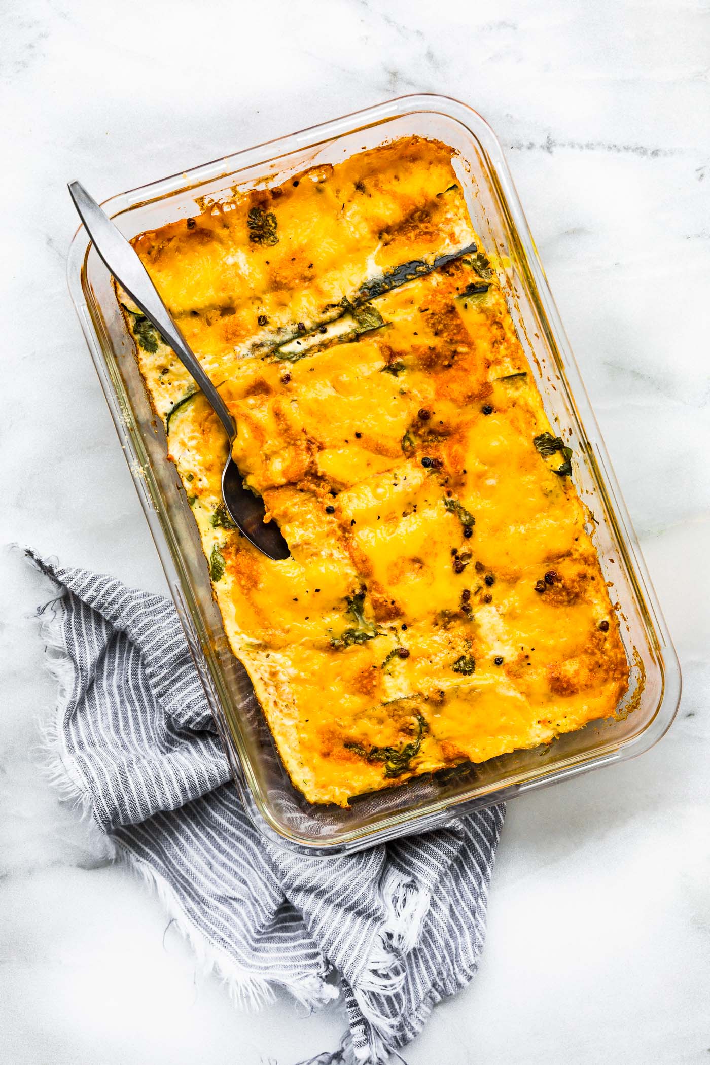 Overhead view egg bake in clear glass casserole dish.