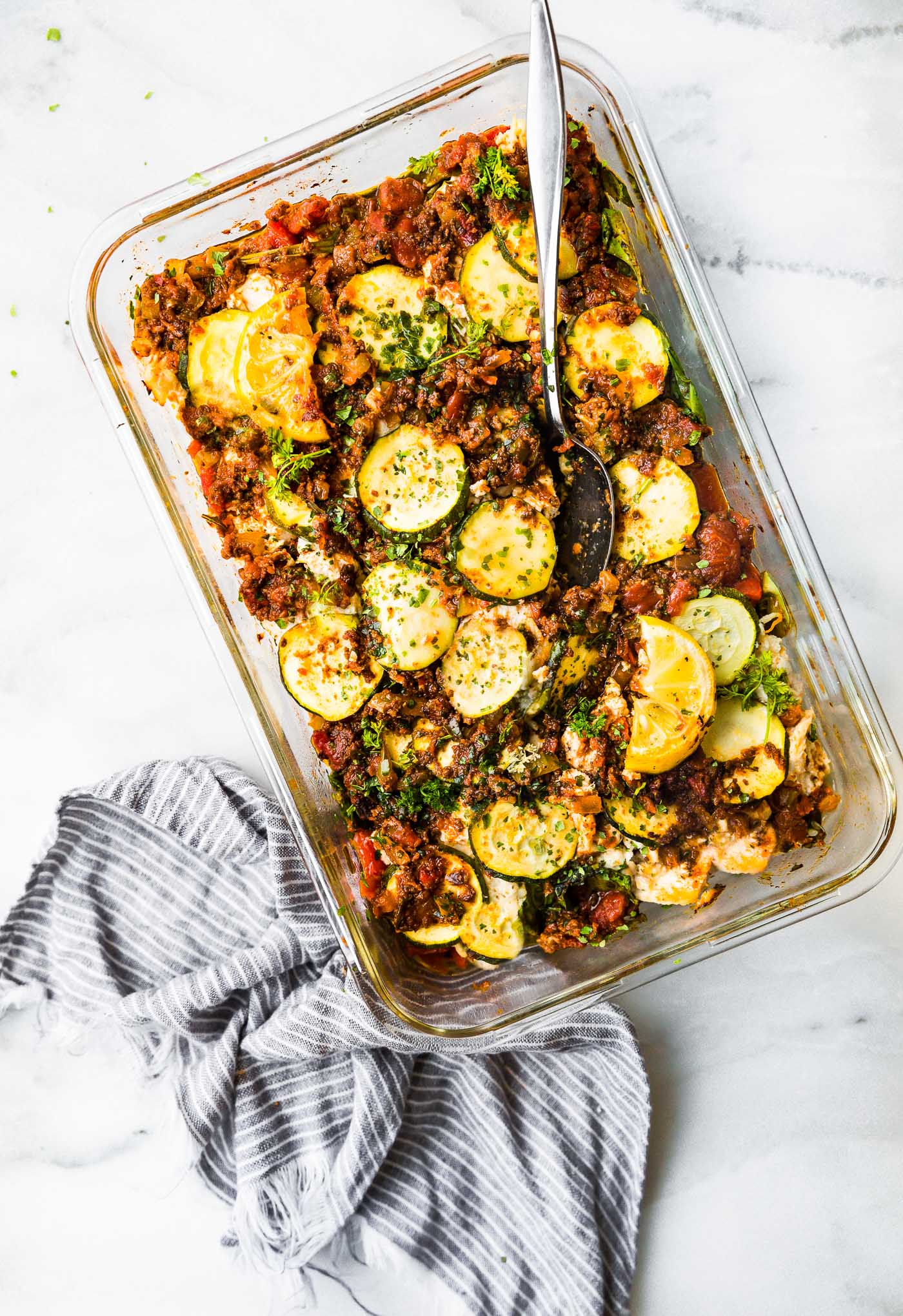 Italian Chicken and Spinach Casserole in clear glass baking dish.