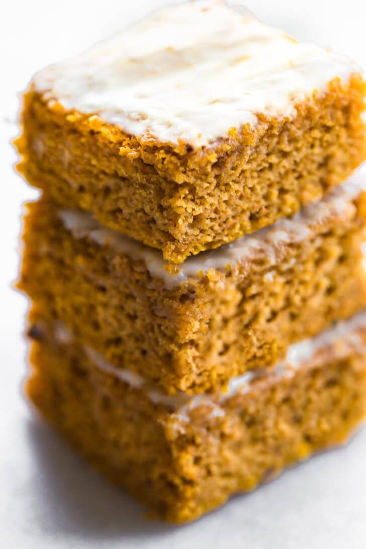 stack of  frosted gluten free pumpkin bars, side angle