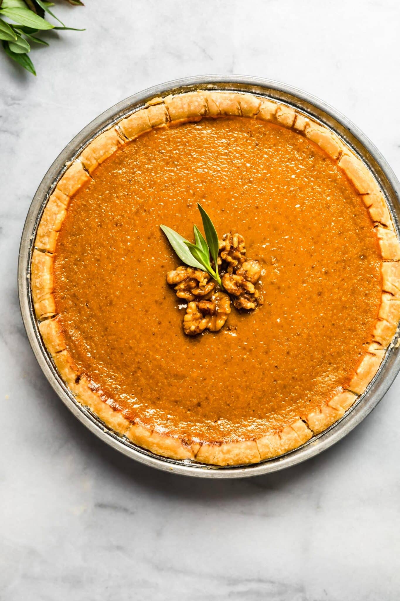 overhead photos of gluten free vegan pumpkin pie with glazed nuts on top