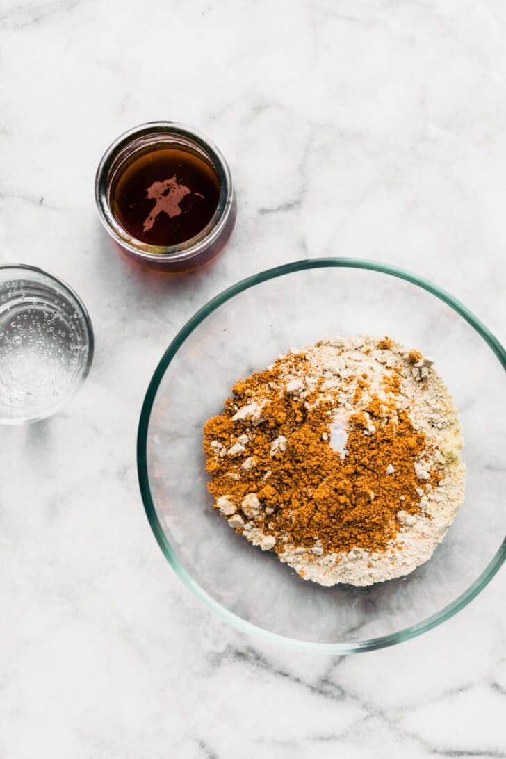 Overhead image of a bowl of gluten-free breading, gluten-free beer, and seltzer.