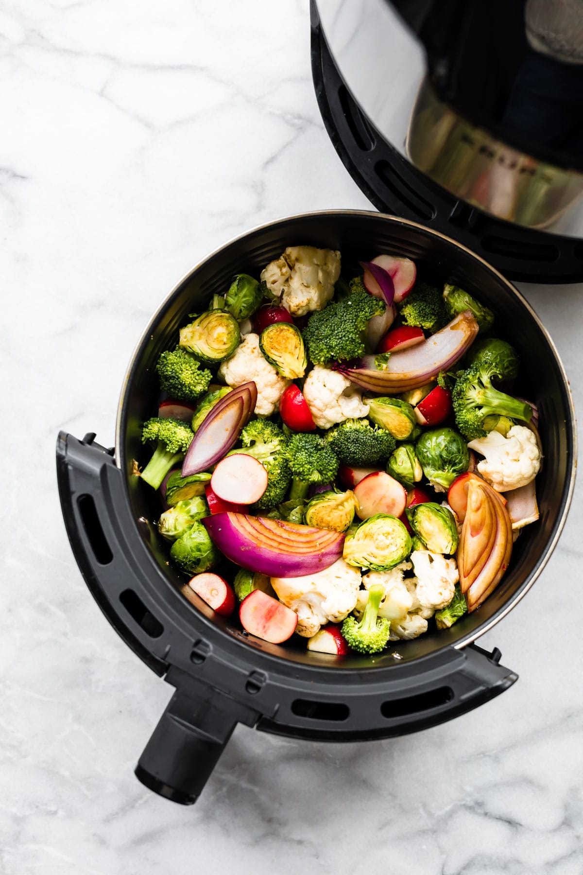 overhead image: air fryer vegetables in basket, ready for cooking