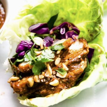 A lettuce wrap filled with Asian BBQ pork.