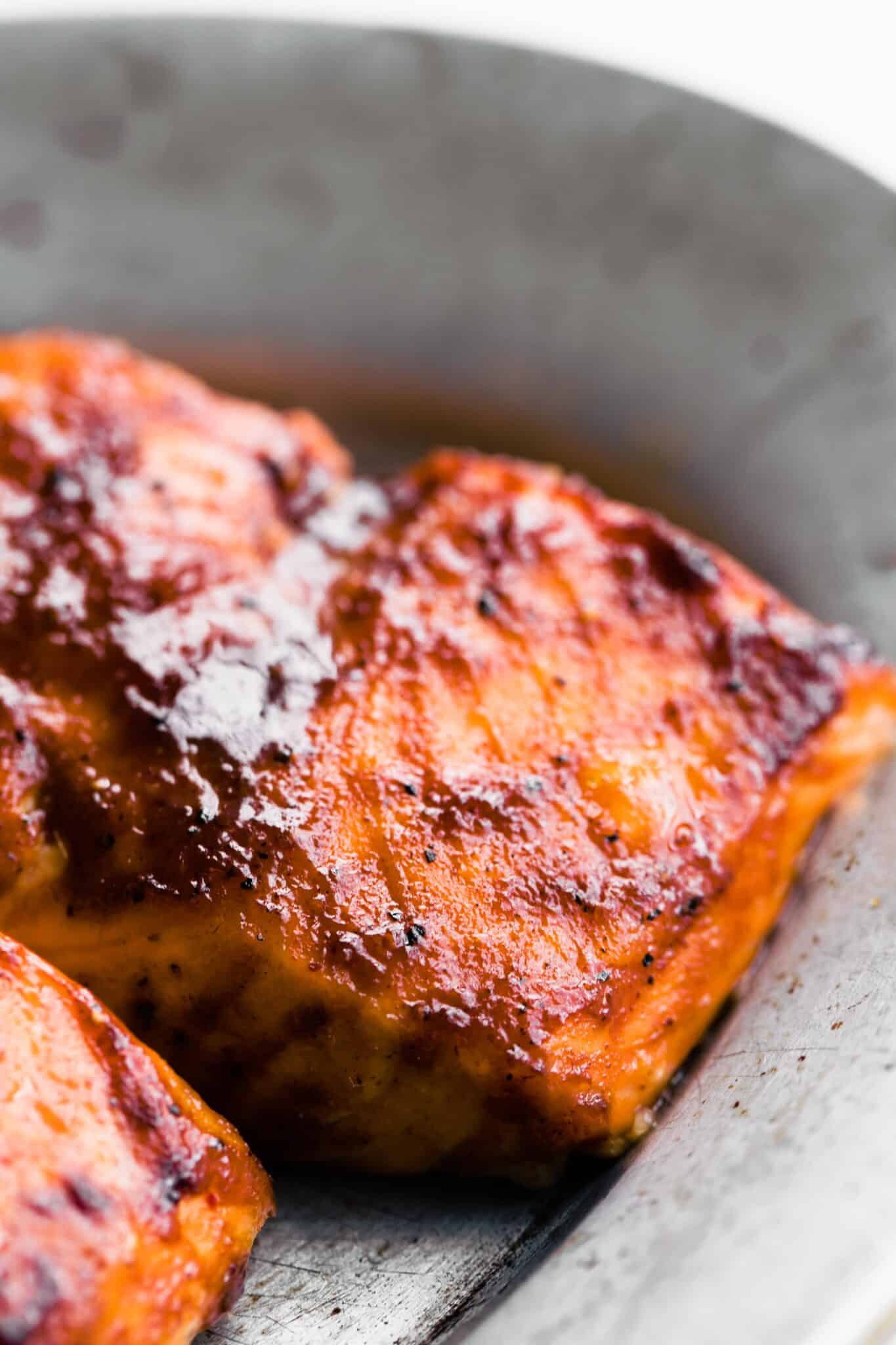 Up close photo of oven baked BBQ salmon on a plate.