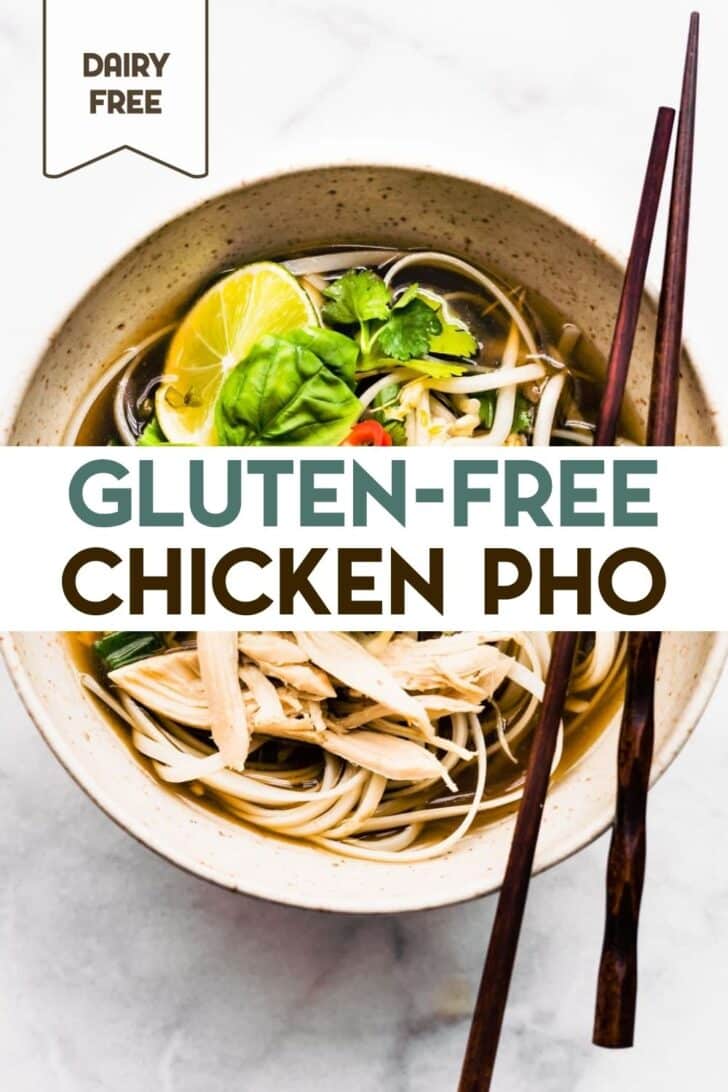 An overhead pho of a ceramic soup bowl of Gluten-Free Chicken Pho Ga with a pair of chopsticks sitting on the edge of the bowl with a text overlay for pinterest.