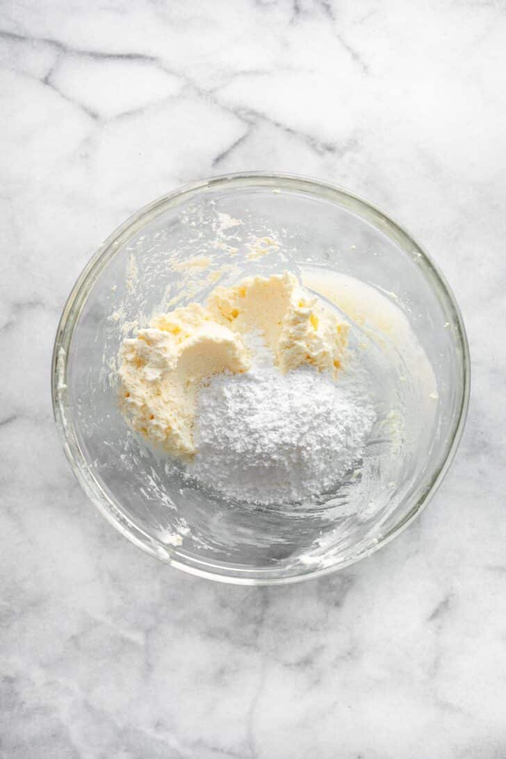 cream cheese frosting ingredients in a bowl.