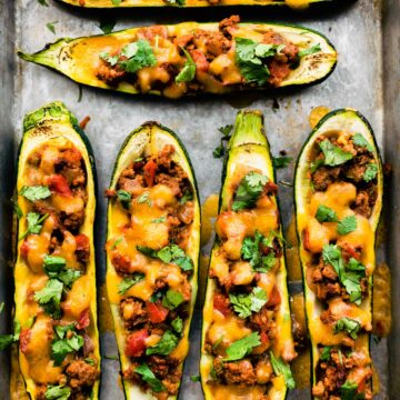 baked enchilada stuffed zucchini boats in a baking dish