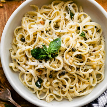 Fettuccine Alfredo in a bowl with fresh herbs