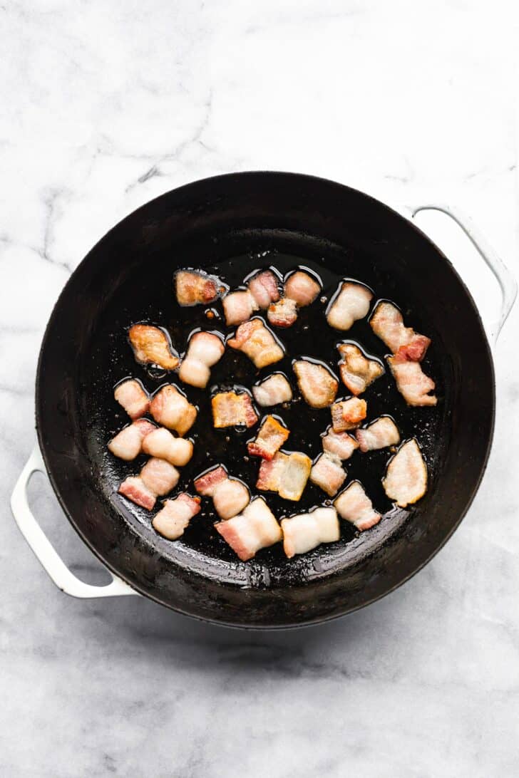 Bacon cooking in skillet for pumpkin pasta