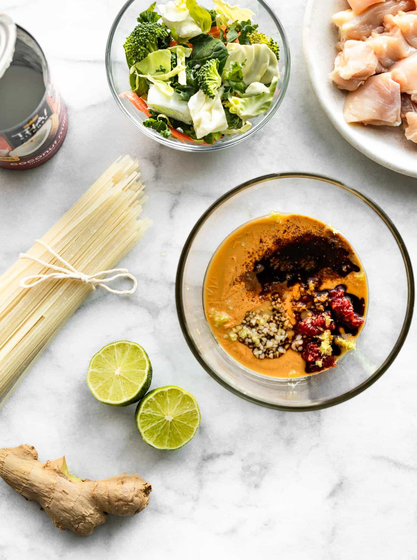Overhead photo of ingredients for one pot Thai peanut sauce noodles on a countertop.