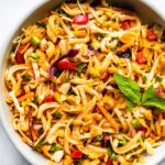 Overhead photo of a cold gluten free Thai noodle salad in a white bowl.