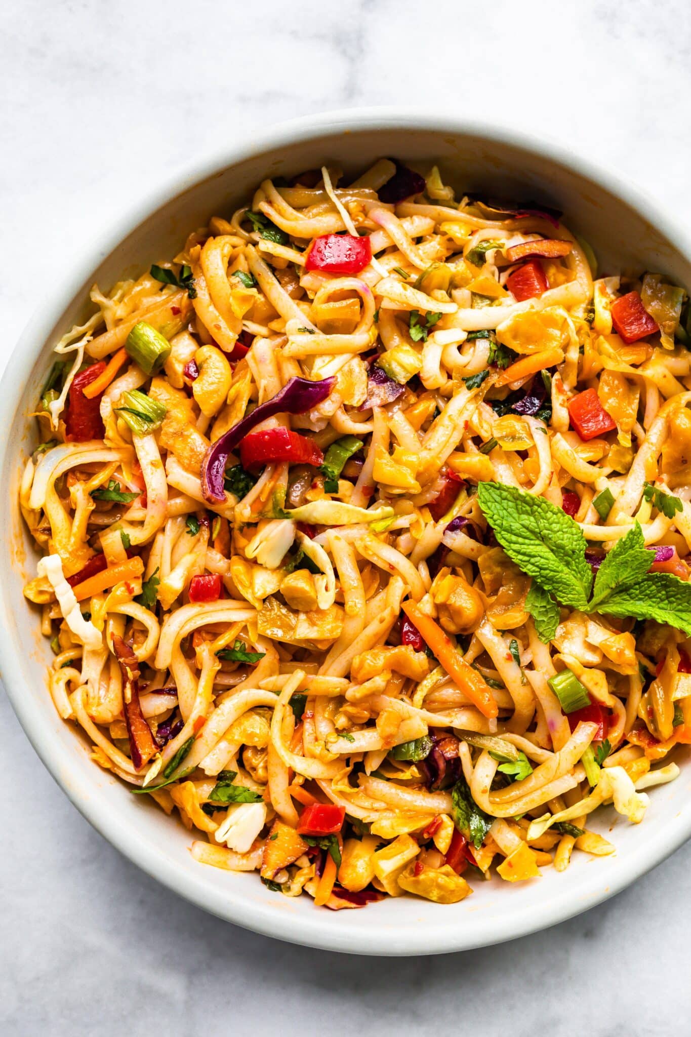 Overhead photo of a cold gluten free Thai noodle salad in a white bowl.