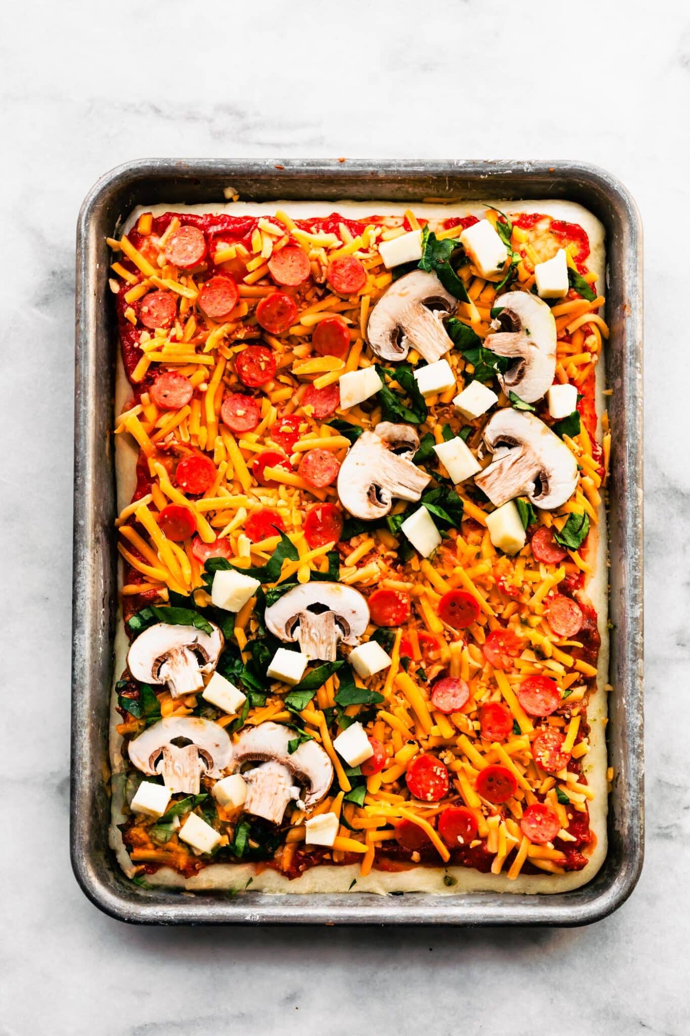 Mini pepperoni, sliced mushroom, chopped spinach and cubed mozzarella on pizza crust.