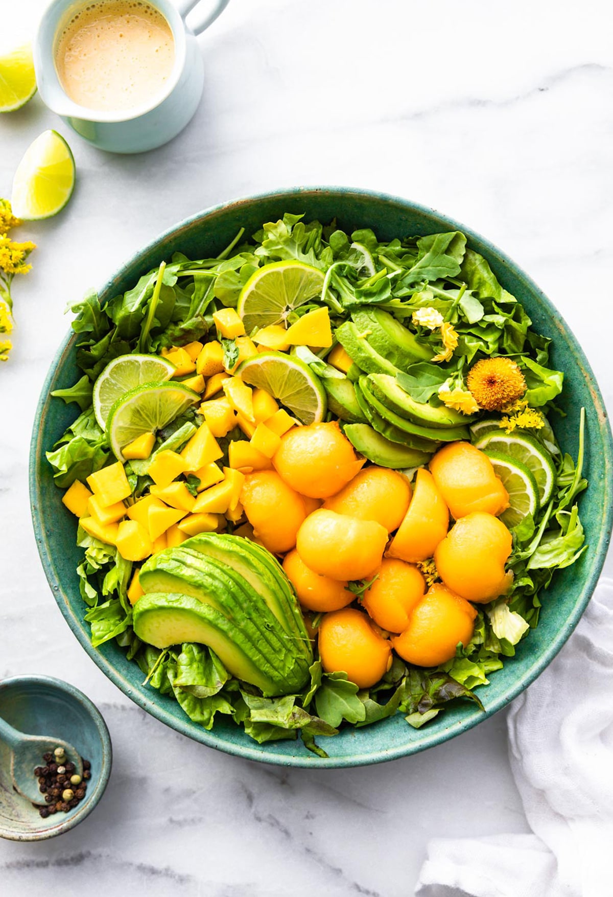 bowl of healthy fruit salad with pieces of mango avocado and cantaloupe
