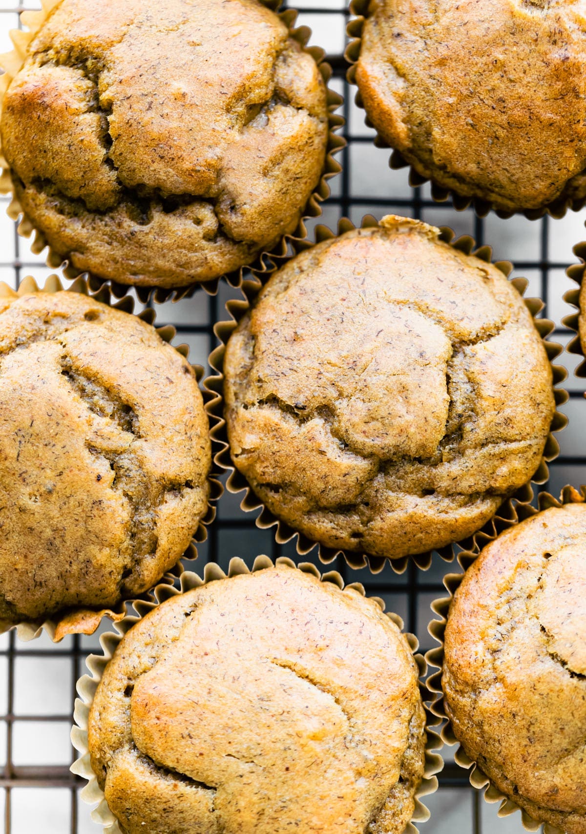 Overhead view of healthy peanut butter banana muffins on a cooling rack.