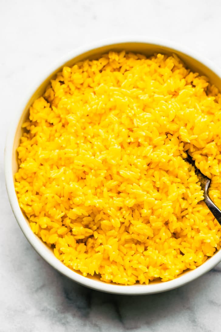 Cheesy orzo mixture in white bowl