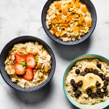 Three bowls of gluten free high protein oatmeal with fresh fruit or chocolate chips.