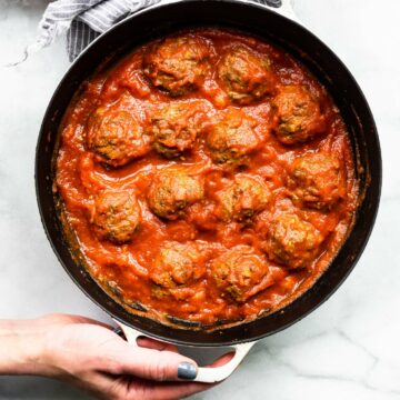 Overhead image of honey sriracha meatballs in a skillet.