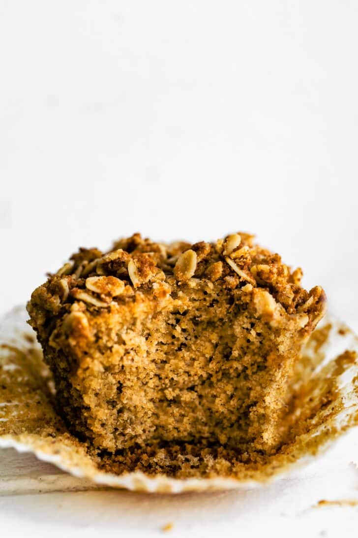 A bite taken out of a honey ricotta muffin.