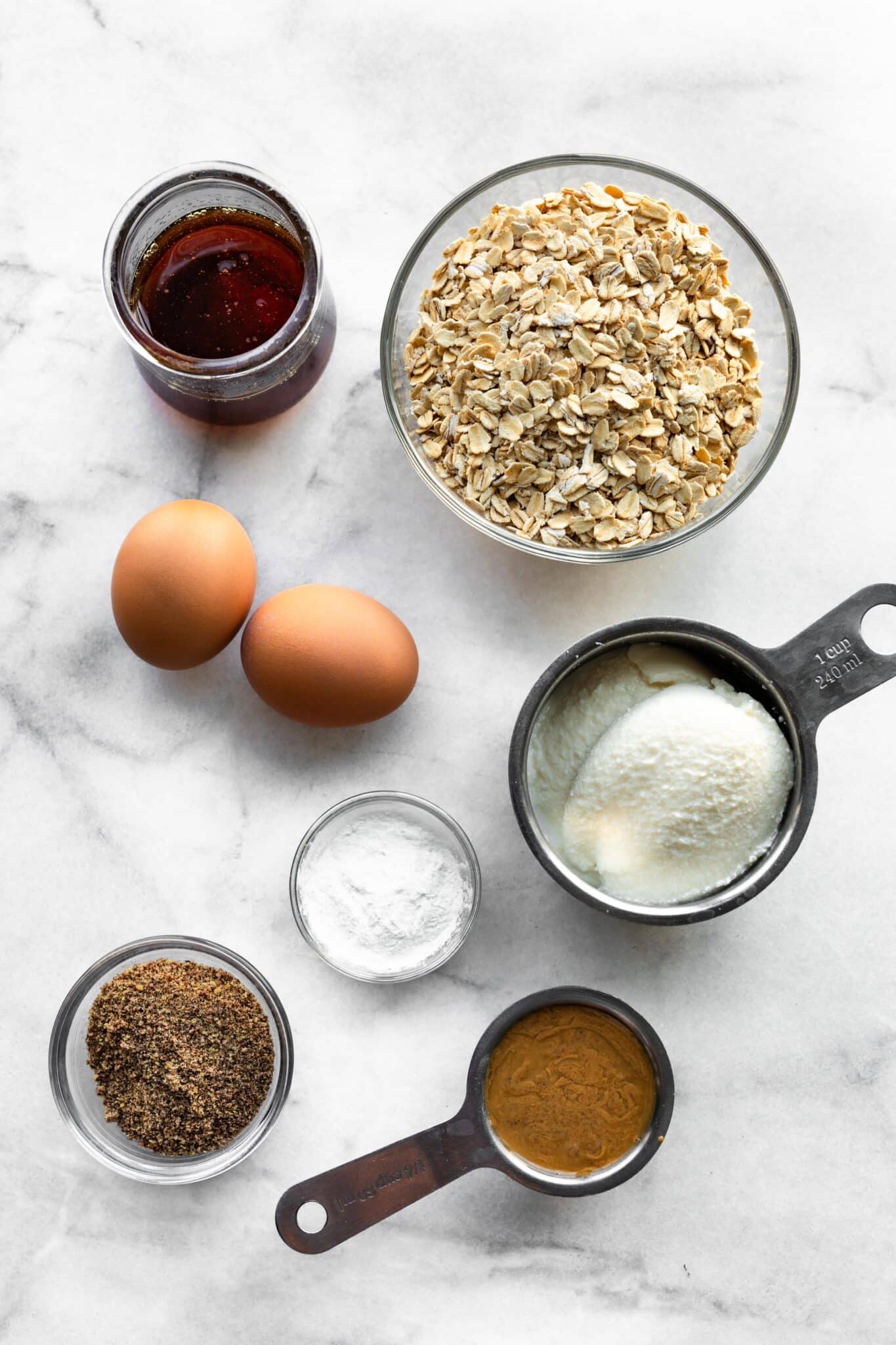 Overhead photo of ingredients for honey ricotta muffins on a white marble countertop.