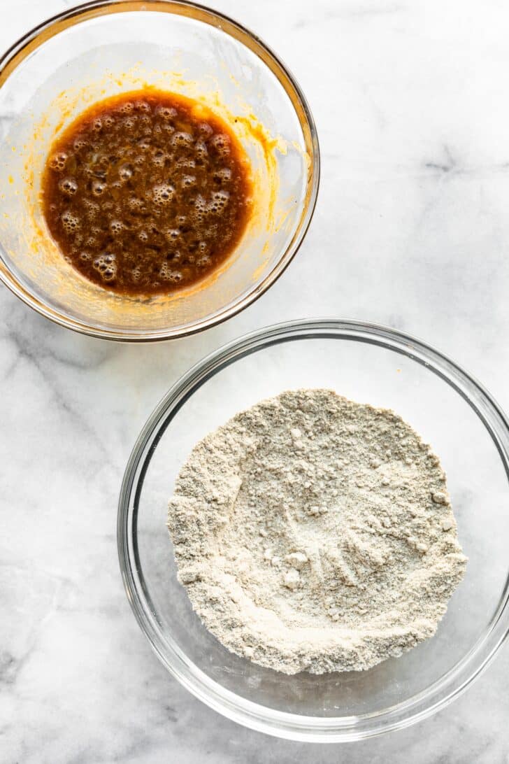 A bowl of dry ingredients and a bowl of wet ingredient.