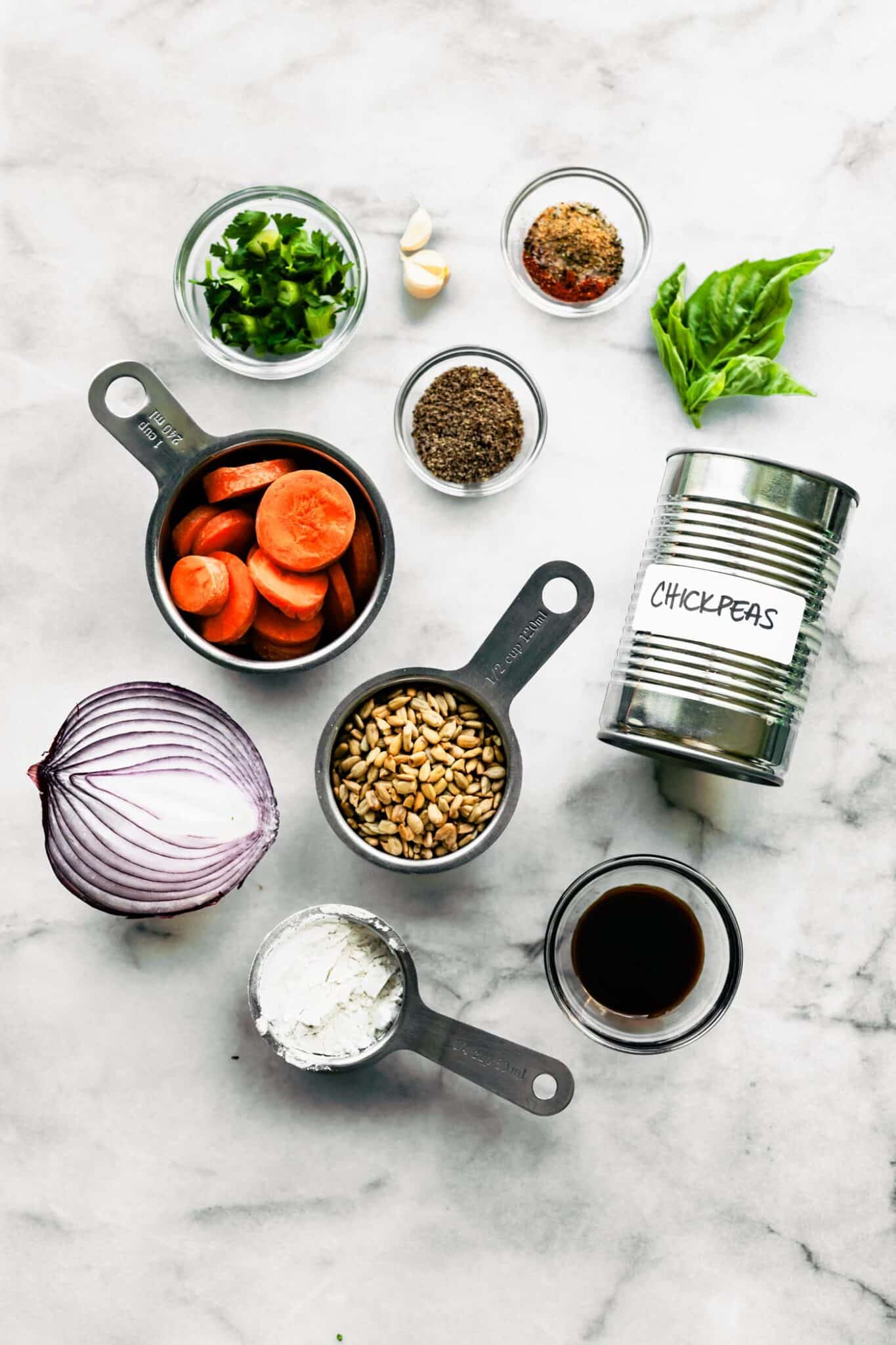 Ingredients for vegan veggie burgers on a white marble countertop.