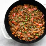 Overhead photo of Korean beef bulgogi in a glazed cast iron pan.
