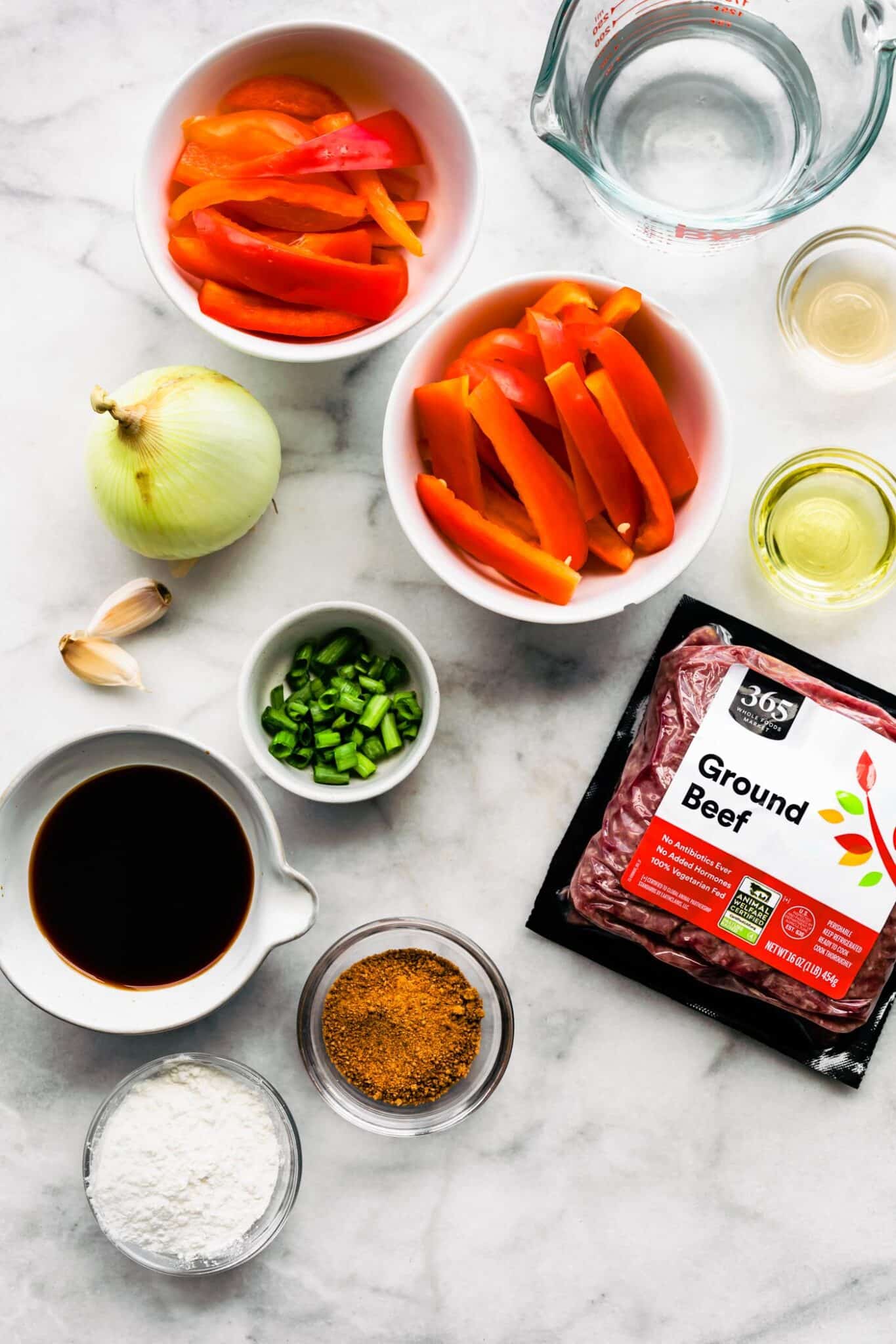 Ingredients for Korean Beef Bulgogi on a white marble countertop.