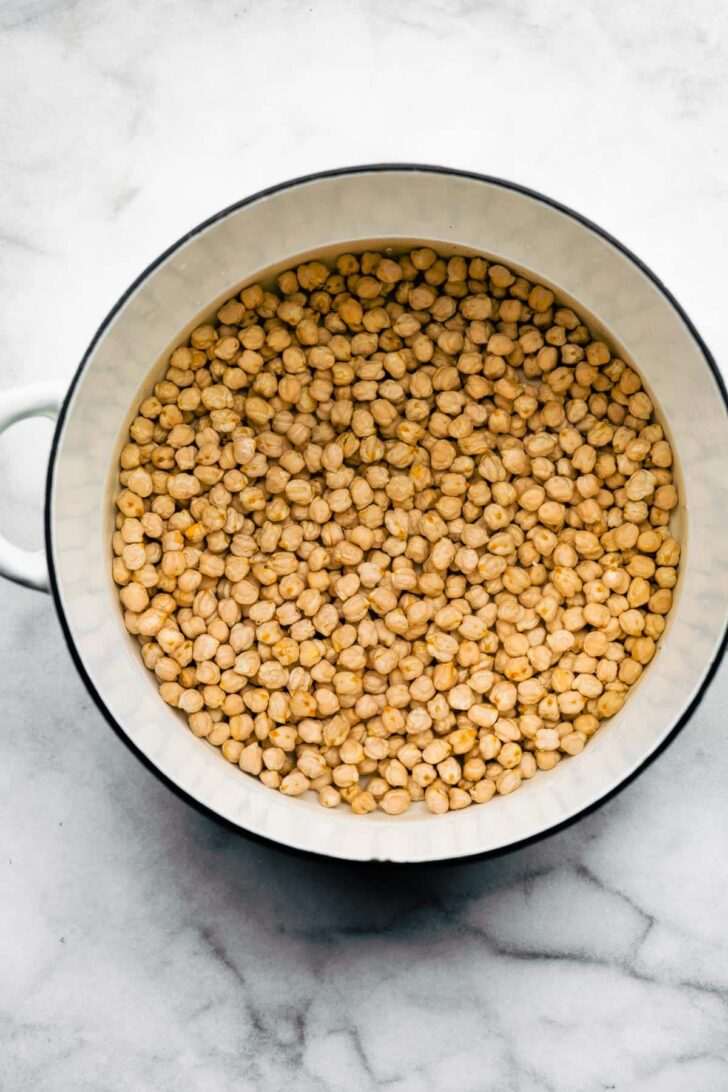 Overhead shot of dried legumes in a pot.