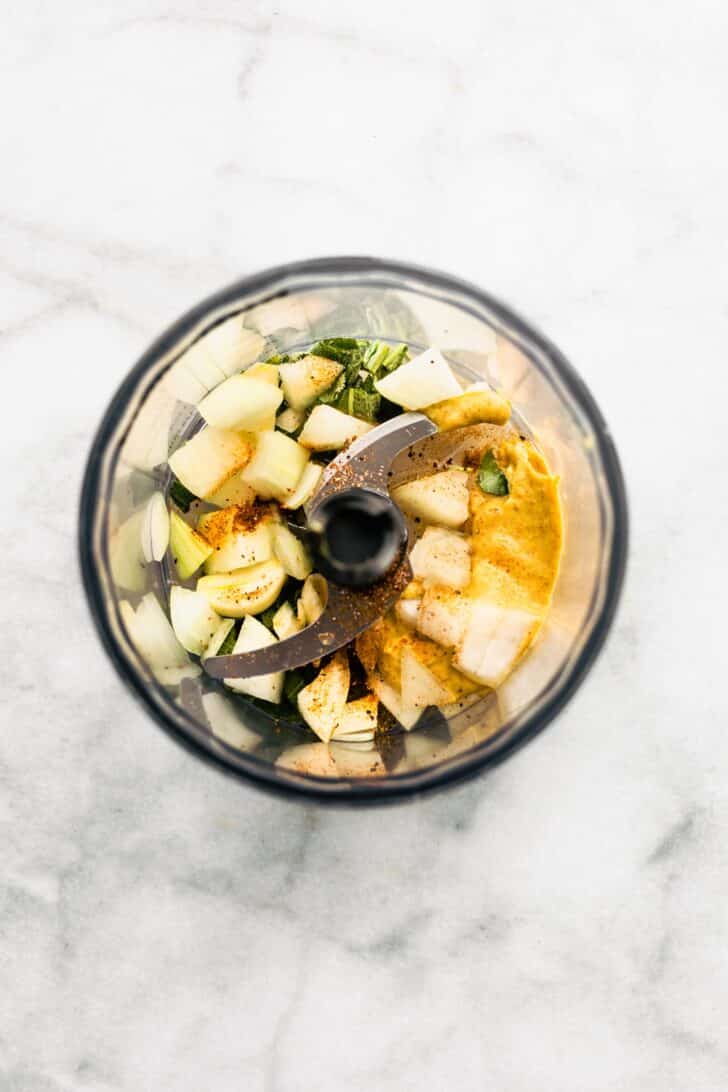 Onion, lemon juice, sage leaves and seasonings in a food processor bowl.