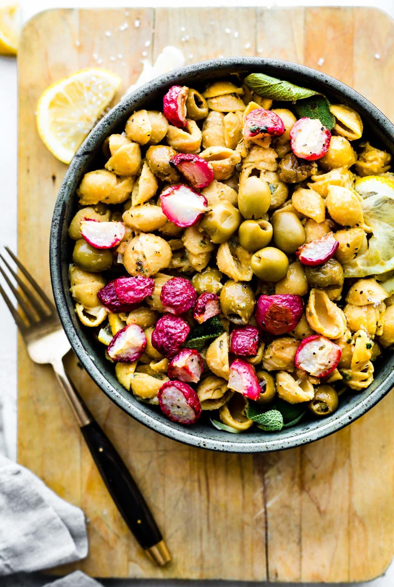 roasted radishes with lemony chickpea pasta in stone bowl.